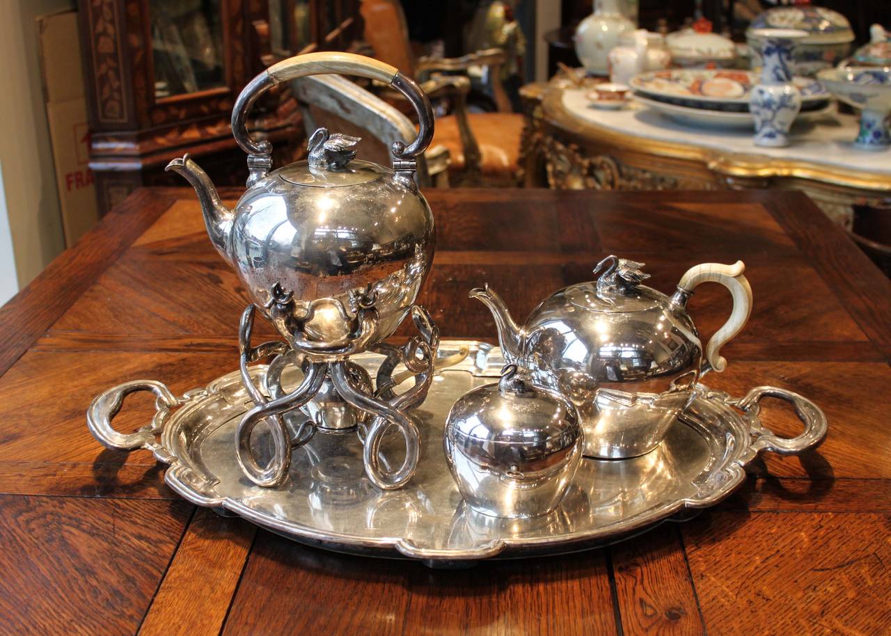 Austro-Hungarian six piece silver tea set with swan motif. Includes kettle-on-Stand, tray, teapot and sugar/tea caddy with lock. 

Measures: Tray: 24