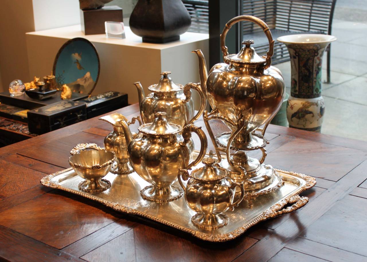 Beautifully decorated and detailed Persian silver tea set. Includes kettle-on-stand, tray, teapot, coffee pot, sugar caddy, creamer and tea caddy. 

Tray: 17