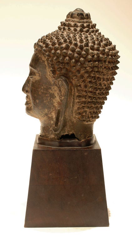 Asian bronze Buddha head on wooden stand 1