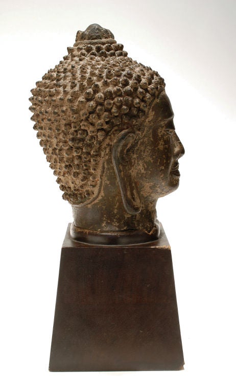 Asian bronze Buddha head on wooden stand 2