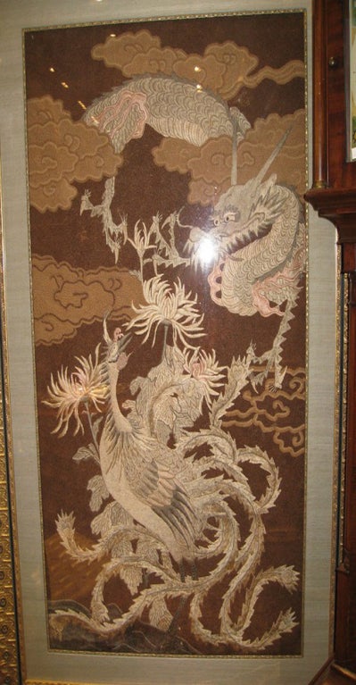 Large and wonderful Antique Embroidery of dramatic Dragon and Phoenix in clouds.<br />
Beautifully framed. 18th - 19th Century