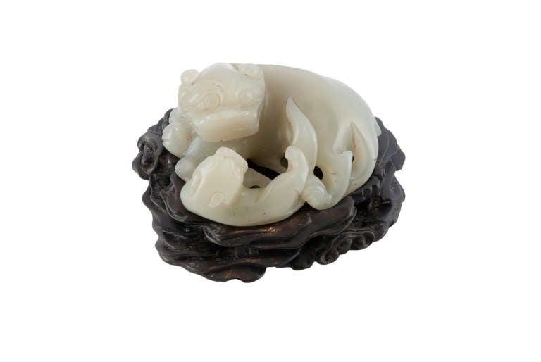 Qing Dynasty Jade Lion and cub in Celaadon jade on Zitan elaborately carved stand.