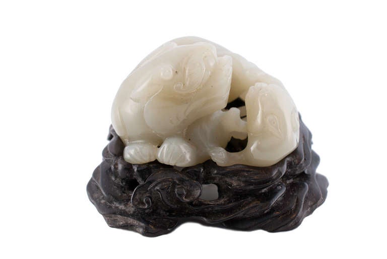 Carved Qing jade lion and cub on Zitan stand