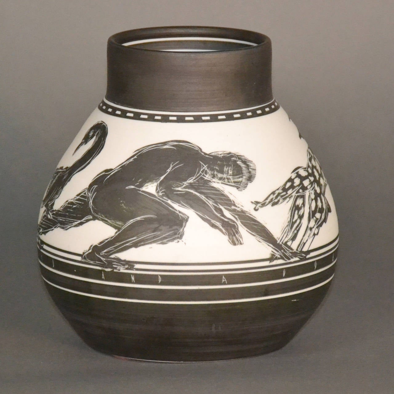 Black and white porcelain vase with detailed etched design and inscription Two- Men- A Bird- And A Dog.  The base is signed E. S. Eberle.