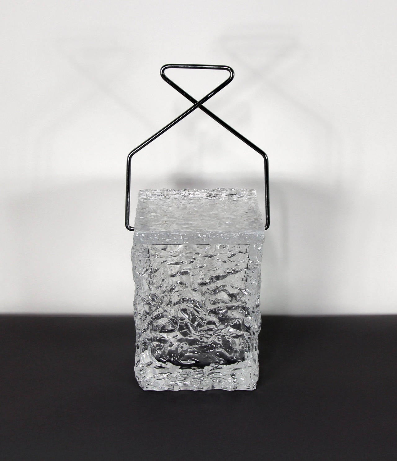 Whimsical ice bucket made of Lucite shaped as a textured ice block with a handle designed as metal ice tongs.