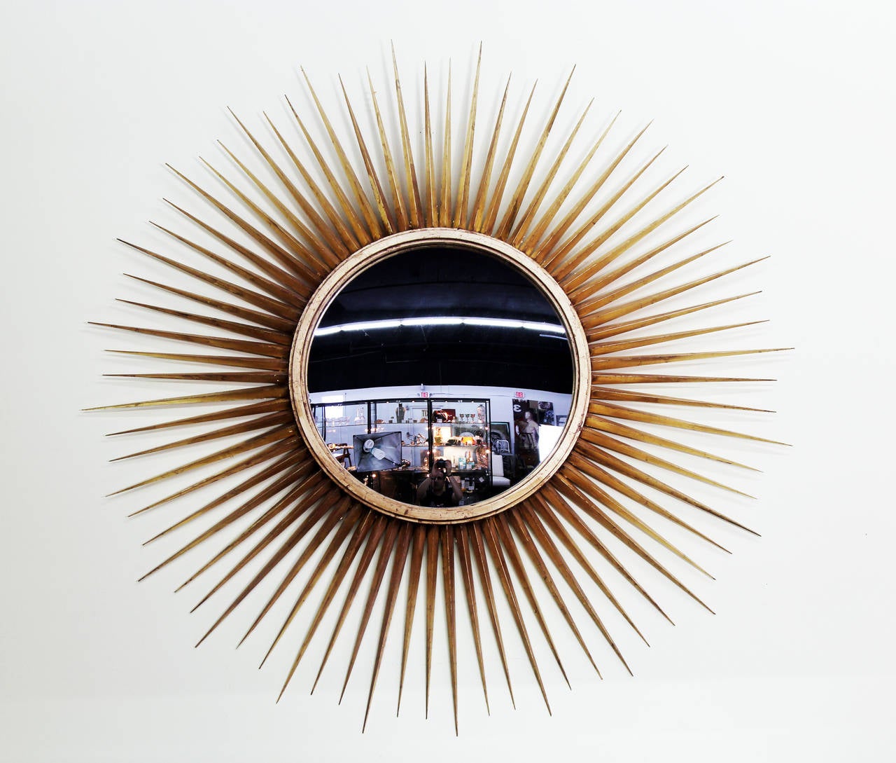 Gold leaf spiney sunburst frame with 18 inch convex mirror. Frame is 48 in diameter.