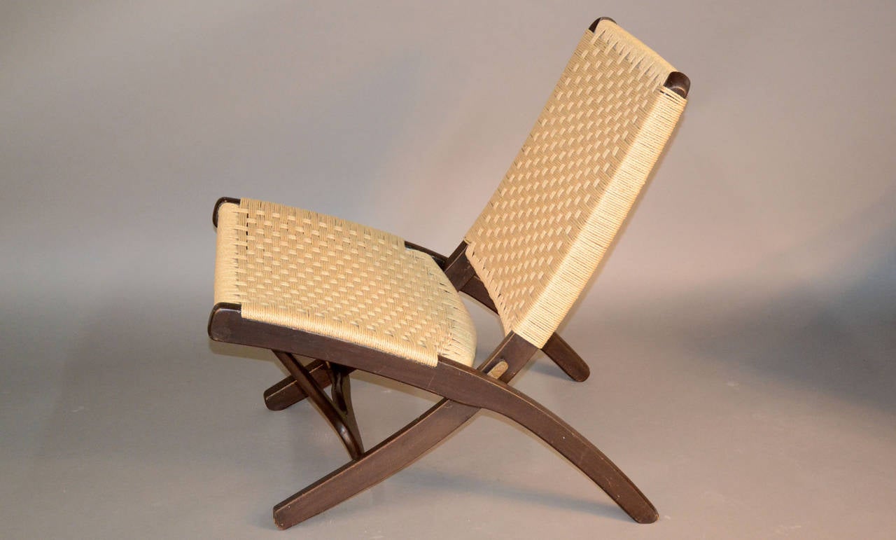 Brand newly chorded and impeccably done. This rare vintage pair of folding rope chairs are amazing.