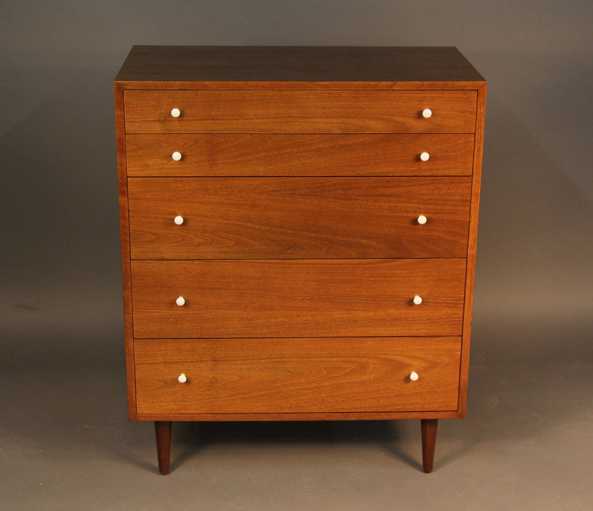 Gorgeous Mid-Century high dresser attributed to Stanley Young, with five drawers in solid walnut. Painted wood knobs, one drawer features built in dividers, circa 1960.
