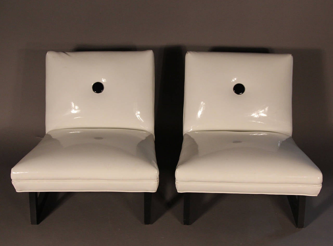 Patent white leather with black button and frame. Low lounge or slipper chairs.
