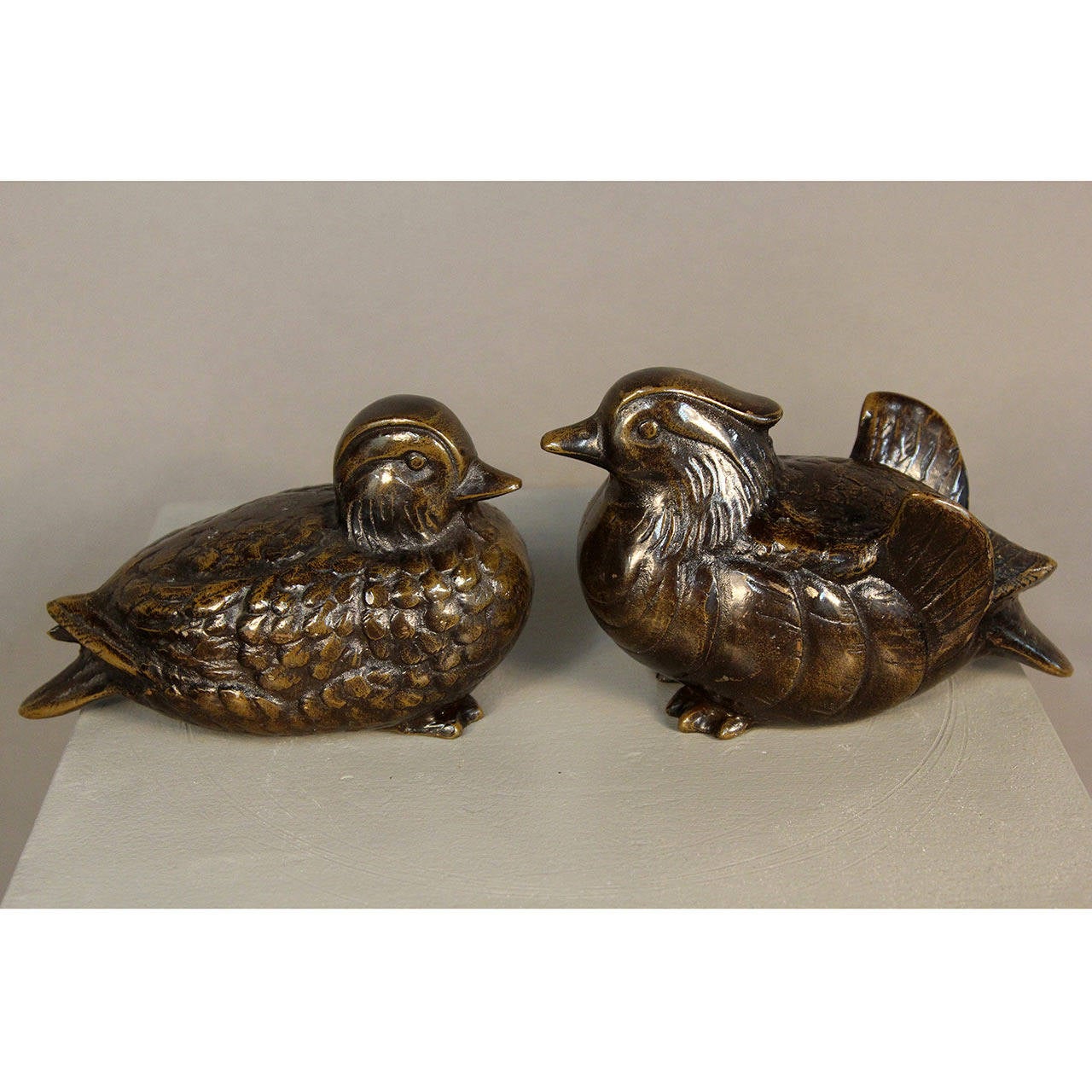 A pair of heavy bronzed spelter mandarin duck bookends. Also lovely as decorative sculptures.
