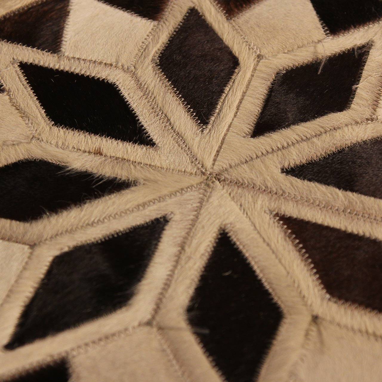 Native American brown and white leather cowhides, possibly used as drum covers, ceremonial mats or simply decorative.