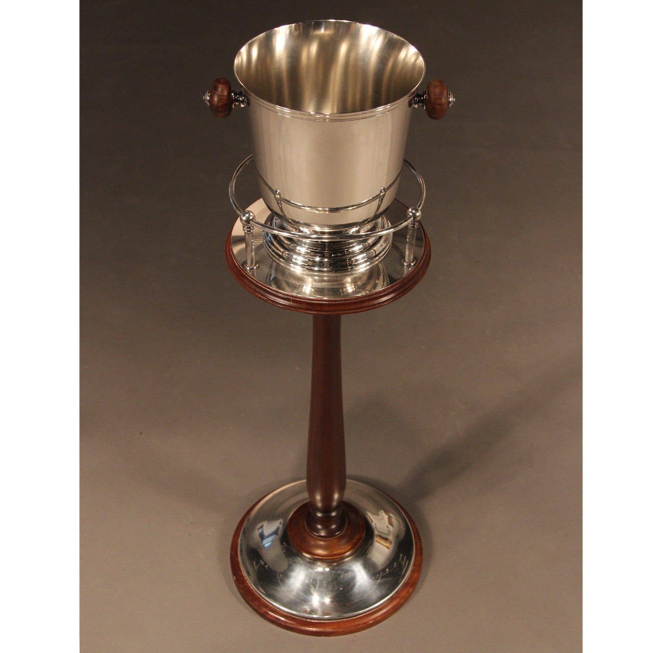 Beautiful silver plated champaign bucket on mahogany Stand by Christofle, France, with turned wood handles. Art Deco style. 

From the home of former Cartier President.