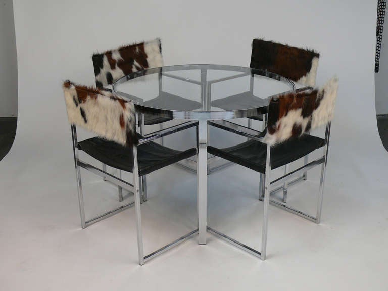 This is a beautiful round glass and chrome table.  The four chairs are chrome frame with black leather seats and cow hide backs.  They are brand newly upholstered.  Chrome is in great shape.