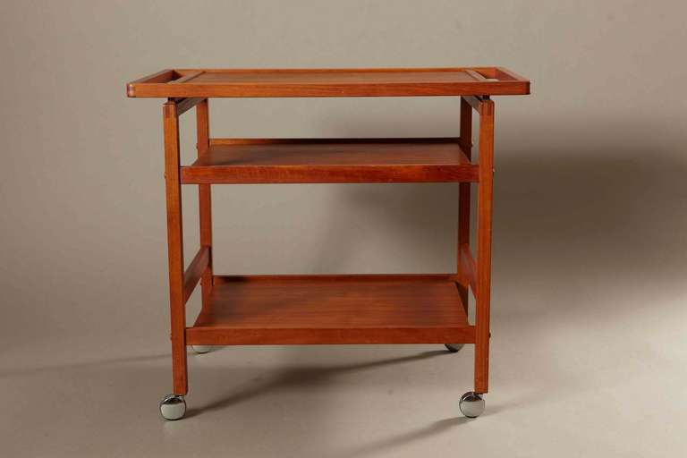 Beautiful BRDR Furbo Denmark teak bar cart on casters. The cart is not labeled. It is in very good vintage condition. It features a removable top serving tray that fits securely to the base. There are minor ring marks.