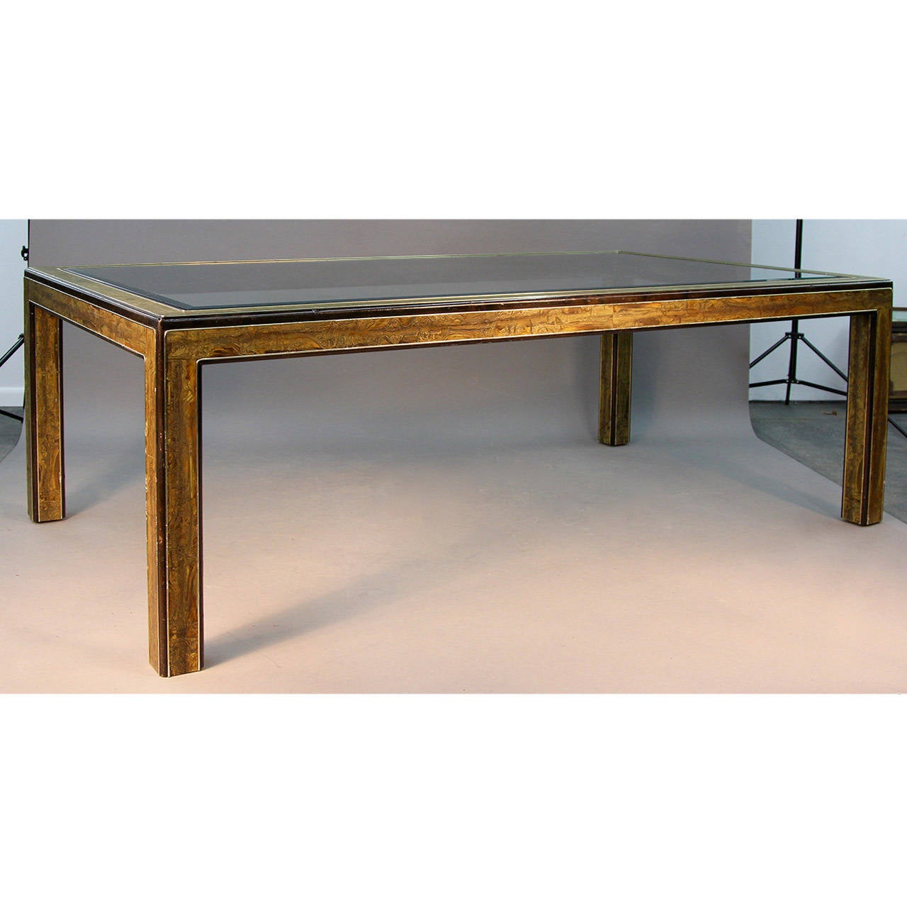 Incredible dining table designed by Bernhard Rohne for Mastercraft. Acid etches brass over wood and beveled glass insert. Incredible style and unique find.