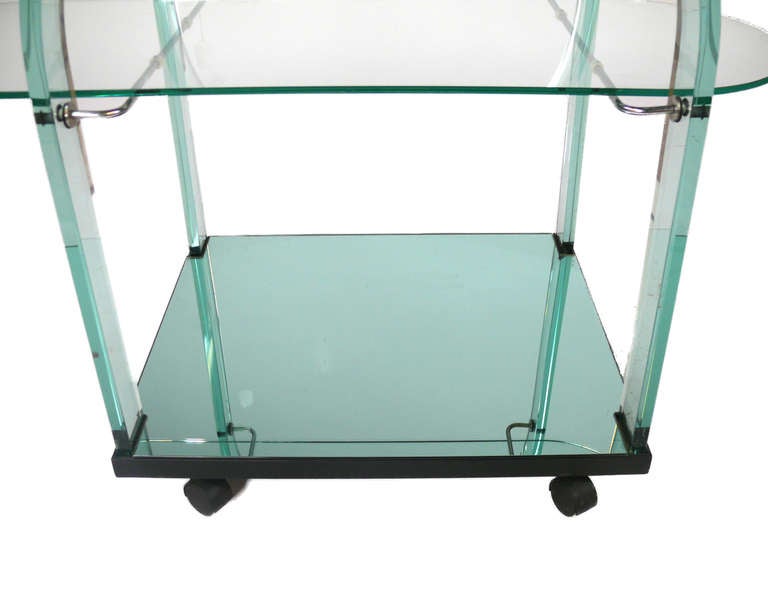 Glass Tea cart 
By FIAM, Italian (Ca. 1970)

Stamped on the base of the arches.
Very useful coffee table.
Center glass surface slides back and forth
and can be removed. 
Distinctly green glass.