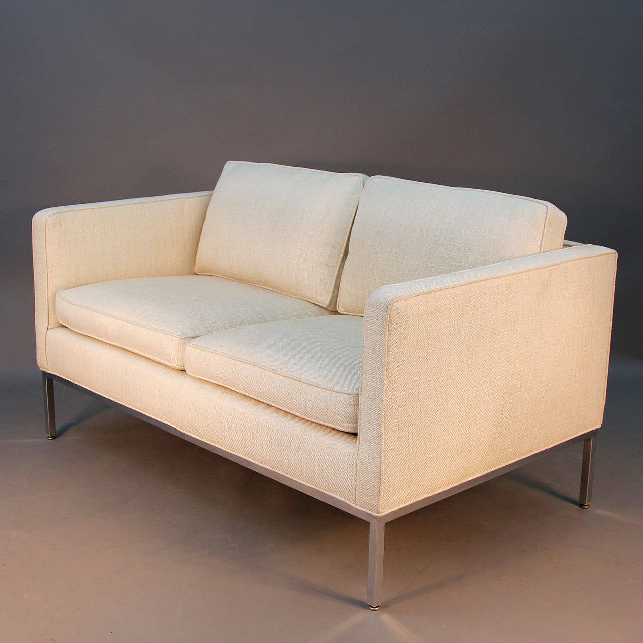 Beautiful off-white linen loveseat sofa with chrome legs and frame design by Milo Baughman for Thayer Coggin with original label. Incredible lines and simple form. Very comfortable piece.