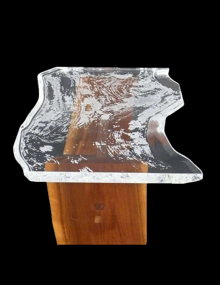 This 1.5 Inch lucite slab is custom carved to the likeness of a slab of walnut wood.  Textured woodgrain carving on bottom and smooth top.  Edges mirror the look and feel of a natural wood slab.  On custom handmade base.  This piece is signed and