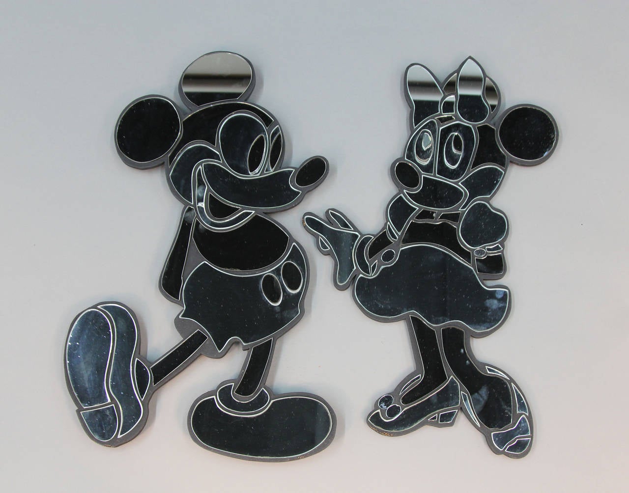 This fantastic pair of mirrors featuring Walt Disney’s beloved Mickey Mouse & Minnie Mouse characters will add whimsy and charm to a child’s room, playroom or any Disney collector’s home or office! Original “Sculptors Guild Ltd., Designs by David