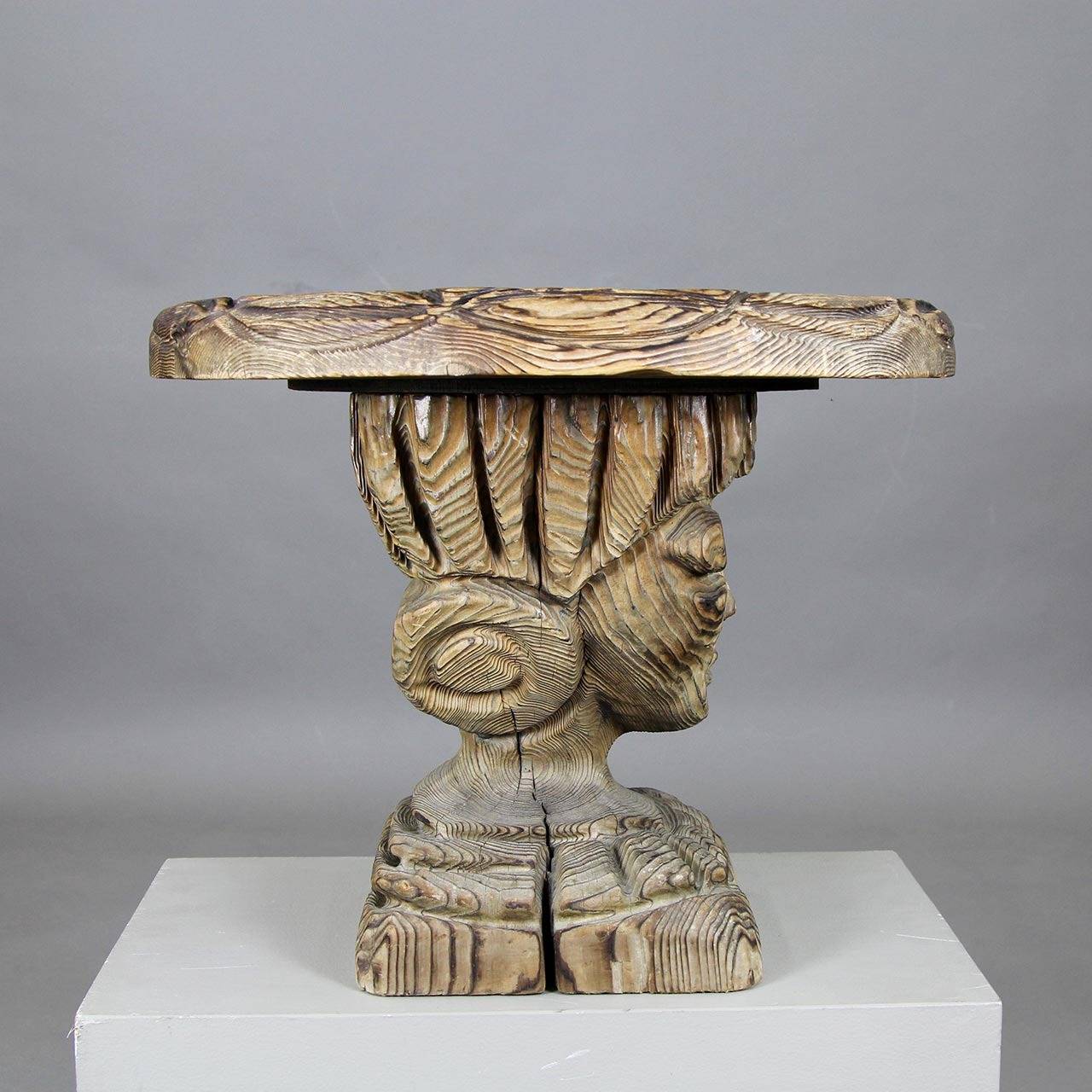 Sculptural carved wood side table.