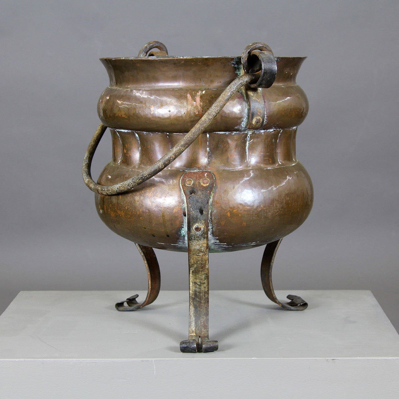 Fantastic 19th century copper footed log bucket with hand-wrought iron bail handle. Impressive and sturdy vessel for holding fireplace logs and tinder, or for use as a wine cooler or decorative planter for flowers or winter or holiday greens.