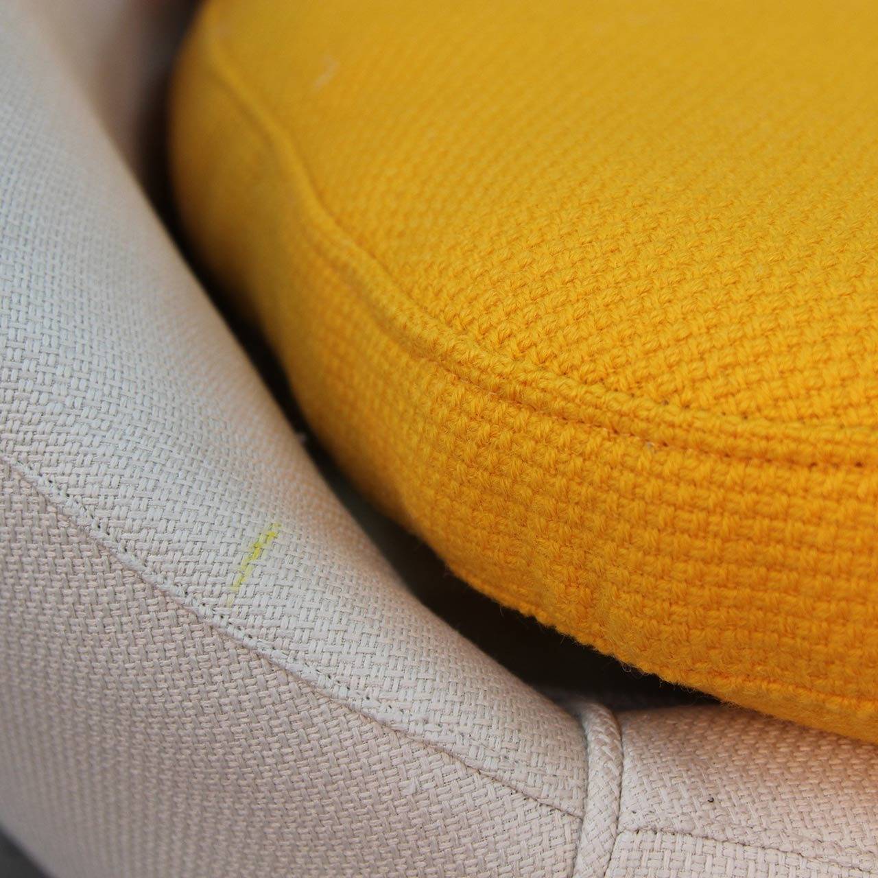 This chair is a lot of fun. I have two sets of cushions for it egg yolk yellow and an off white shell set which matches the outside upholstered surface. I did a survey and the consensus was the egg yolk yellow was the choice of the majority. Its a