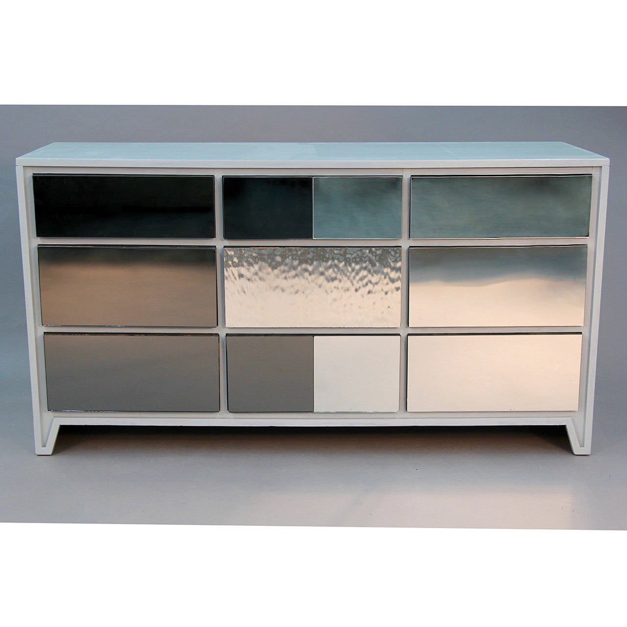 Drab Gray 9 Drawer Mid Century Chest with Mirrored drawer fronts. The color is on the cusp of gray/ blue. Like the space between a cloud and the sky.A stain was developed to create the color. Conventional mirror juxtaposed with tinted charcoal