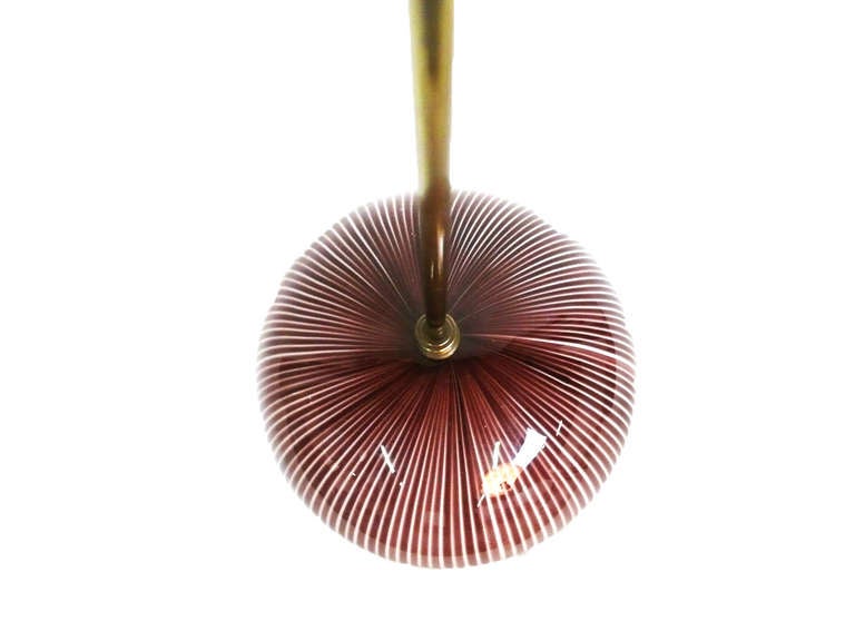 Venini Italian pendant light designed by Massimo Vignelli.  Brass mount and rod, striped glass shade in Italian glass.
