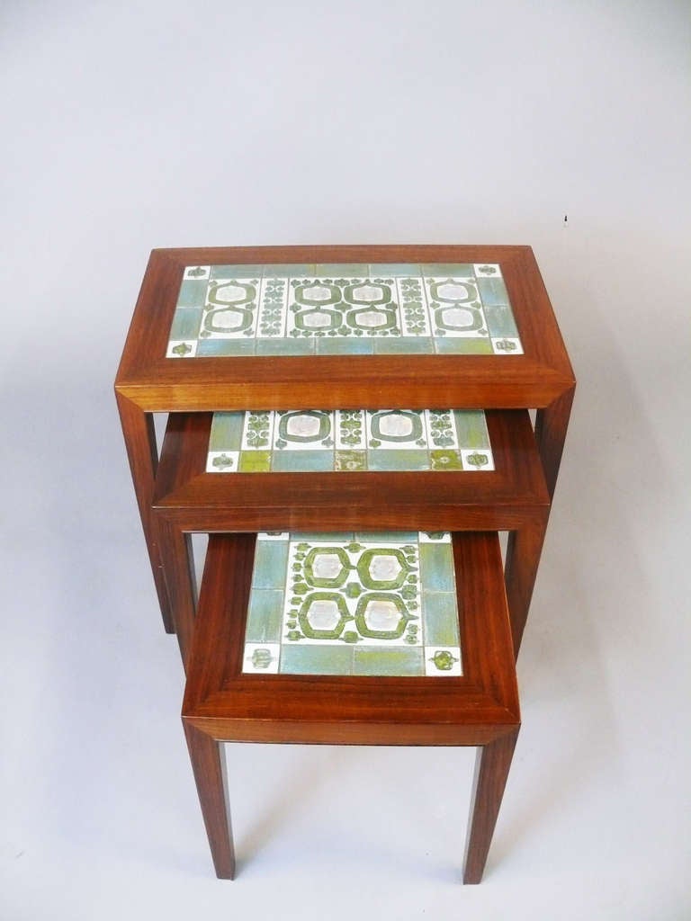 Set of Three Rosewood Nesting Tables by Severin Hansen Jr. with Handmade Ceramic Tiles by Royal Copenhagen of Denmark. Designed by Severin Hansen Jr. and manufactured by Haslev Mobelsnedkeri. Tiles By Royal Copenhagen.