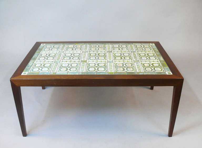 Beautiful rosewood coffee table inlaid with handmade tiles manufactured by Royal Copenhagen of Denmark. Designed by Severin Hansen Jr. and manufactured by Haslev Mobelsnedkeri. Tiles made by Royal Copenhagen