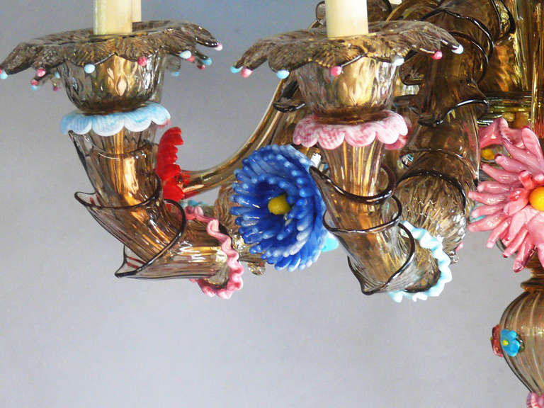 Very intricately detailed murano glass hanging chandelier.  Brass tone-smoked glass body with vibrant colored floral elements.  Imported from Porte de Clignancourt