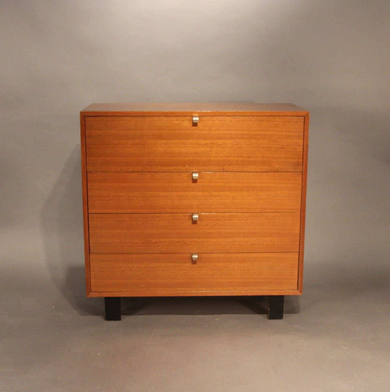 Three drawer dresser chest with fourth drawer being a drop down secretary with desk organizer compartments. Brass pulls, black painted legs. A true example of Mid-Century design and function.
