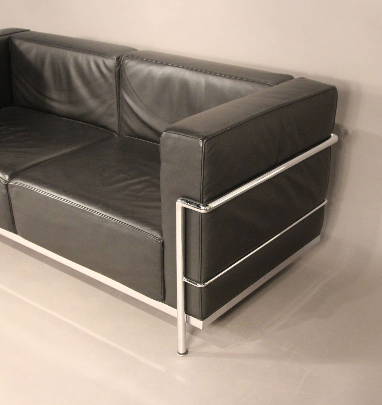 Iconic Le Corbusier LC3 loveseat in like new condition. Black leather with chrome tubing. This is a modern example from design within reach in almost perfect condition.