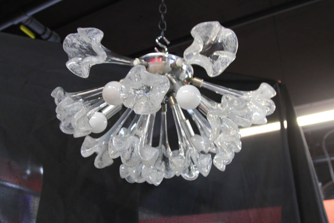 Six-light Italian Mid-Century Modern chandelier. Chrome flush mount with 15 handblown speckled lilies.