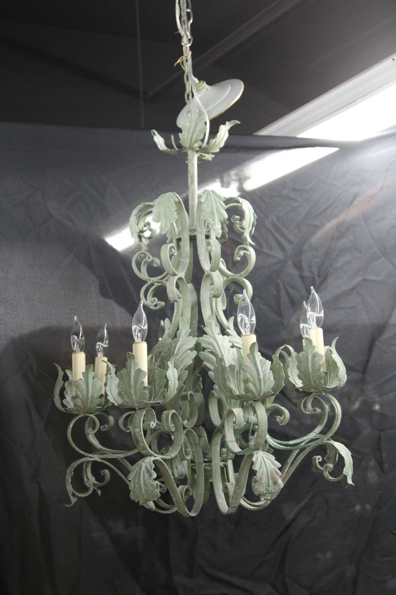 Green tole painted eight-arm newly electrified chandelier.