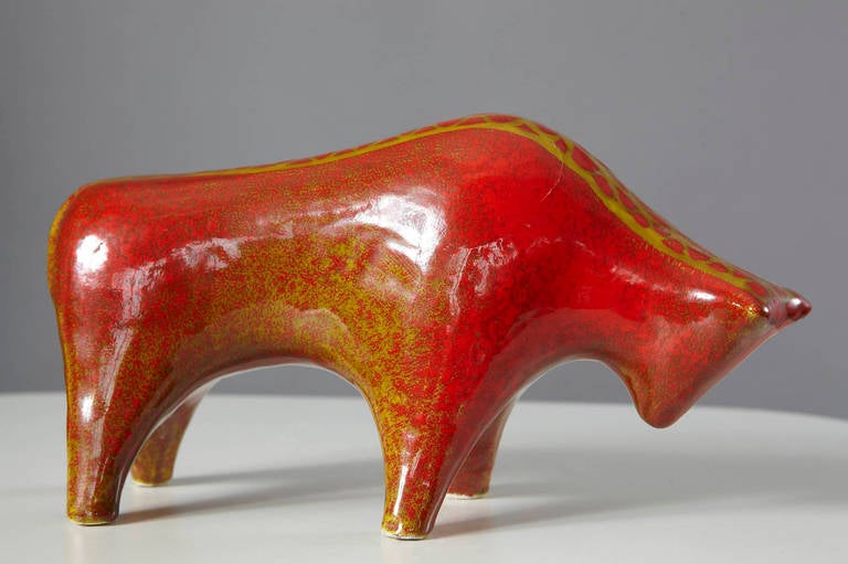 Ceramic sculpture of a bull with red, yellow and beige glaze. Attributed to Alvino Bagni. The sculpture is signed on he bottom R 3323 Raymor, Italy.