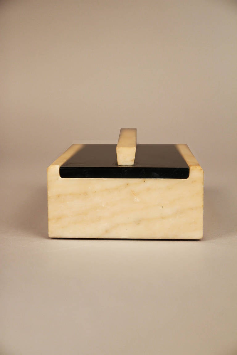 Art Deco Marble Box with Sliding Lid

Finely crafted unpolished crema marble box and handle with black polished marble lid. Lid slides open to reveal graceful sloped interior. Great angle edge detail on lid handle.