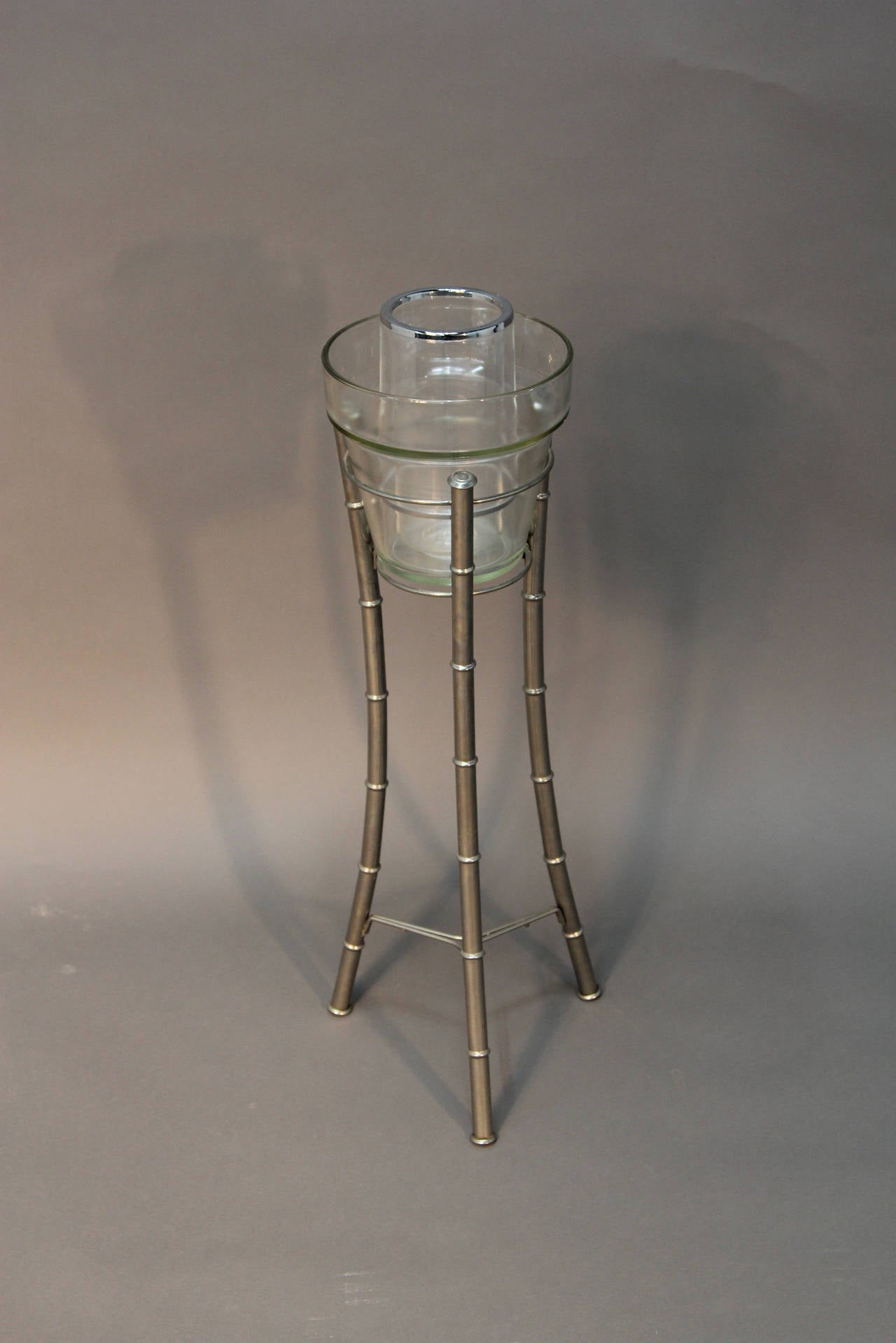 Glass ice bucket with Lucite wine chiller stand atop a faux bamboo chrome stand. Nice Hollywood Regency piece.
