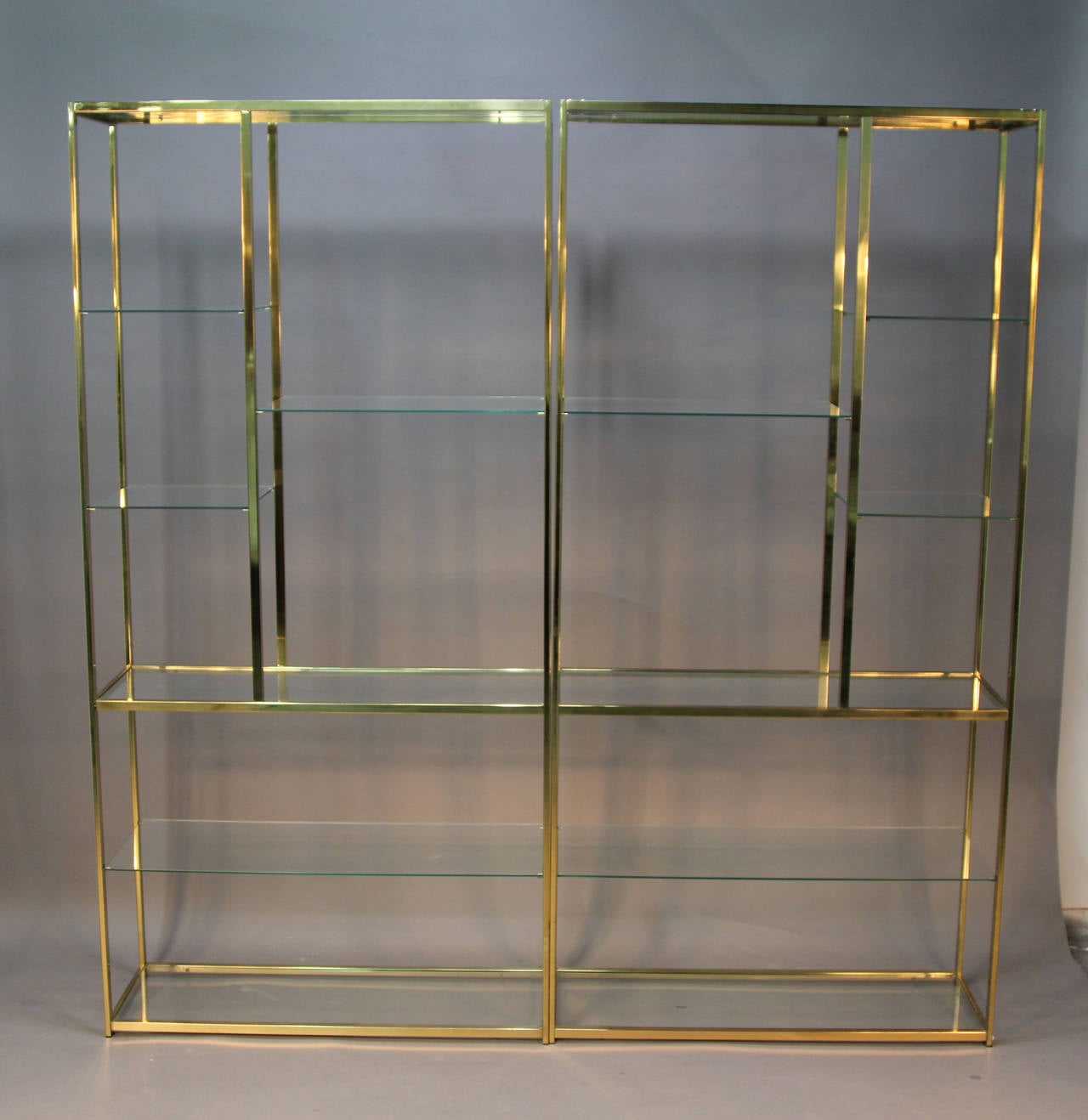 Pair of incredible Brass and Glass etageres.  Milo Baughman multi tiered shelves.  Geometric pattern shelves.
