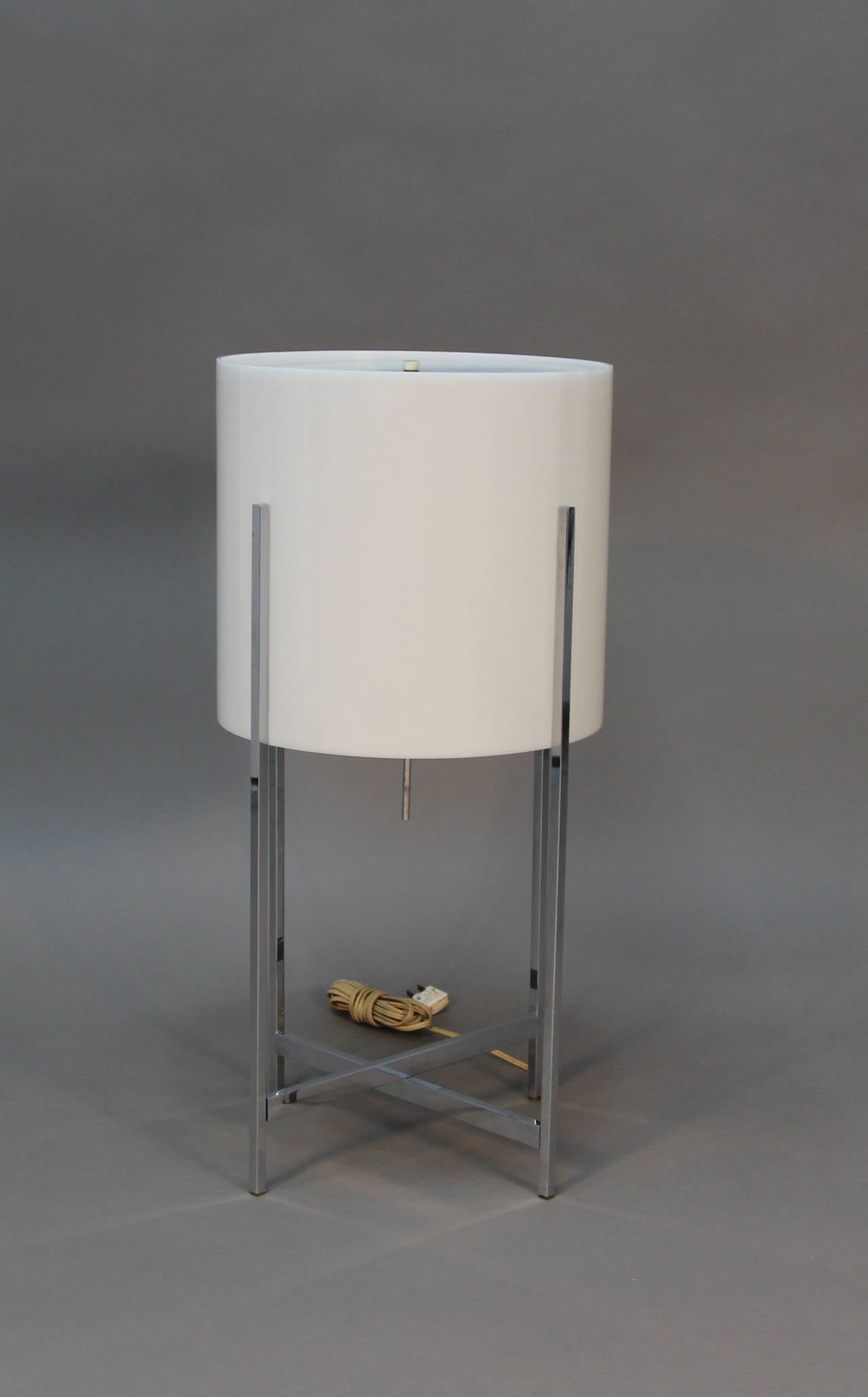 Beautiful Habitat lamp with criss cross chrome legs and white Lucite shade.