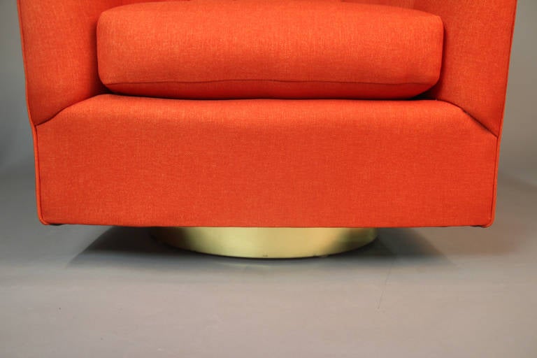 American Pair of Orange Channeled Swivel Club Chairs with Brass Bases