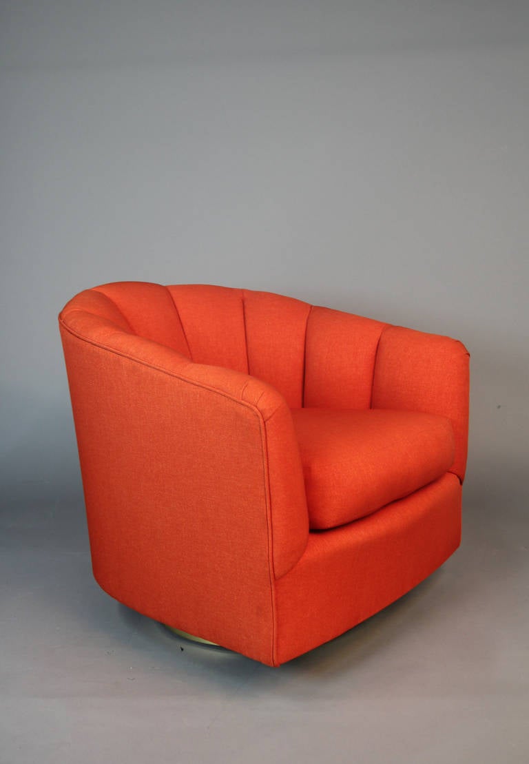 Gorgeous pair of channel back swivel club chairs.  Beautiful brass base and brand newly upholstered orange cotton fabric.  Milo Baughman Style.