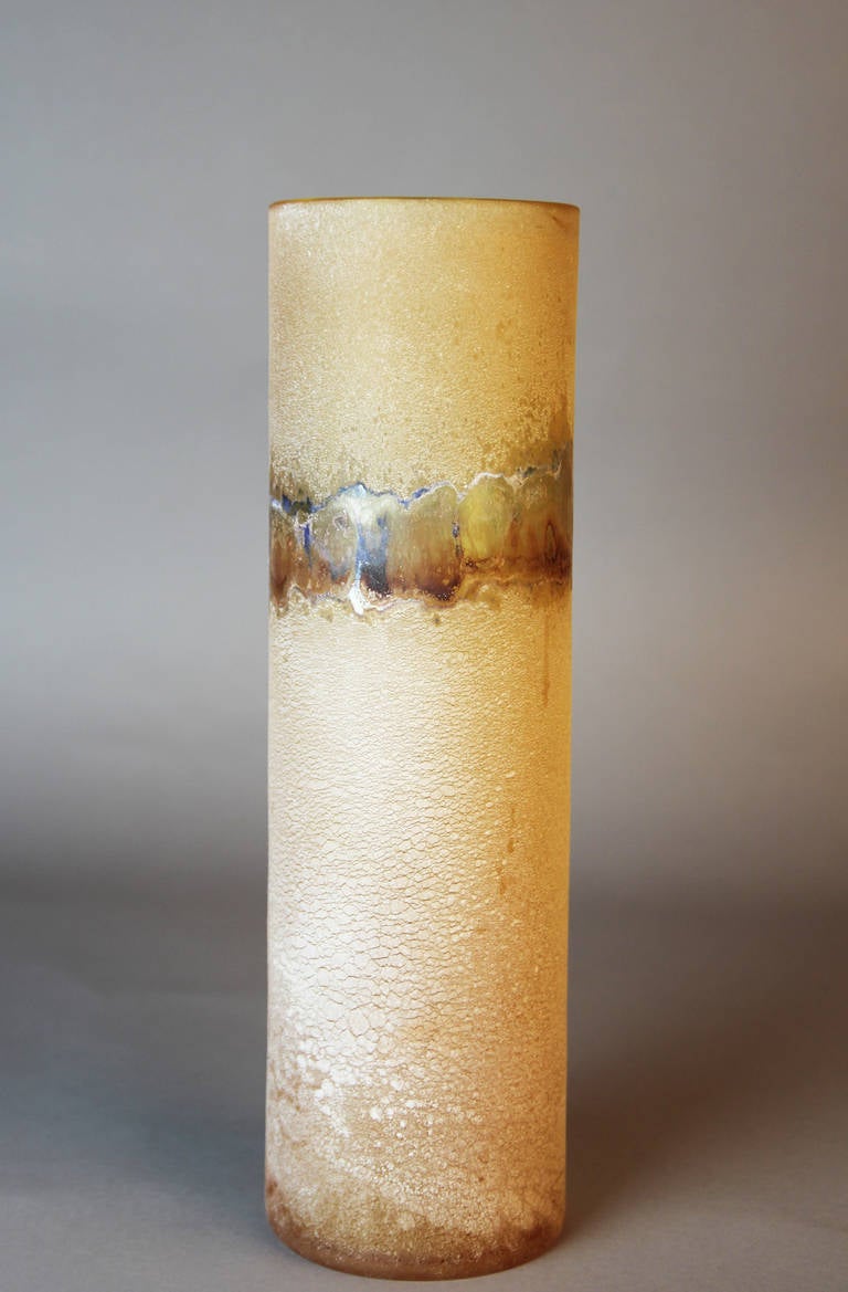 Tall cylindrical Murano glass vase in amber with a Scavo textured finish. This vase has a band of deep amber with blue highlights. Signed to the base Barbini Murano.