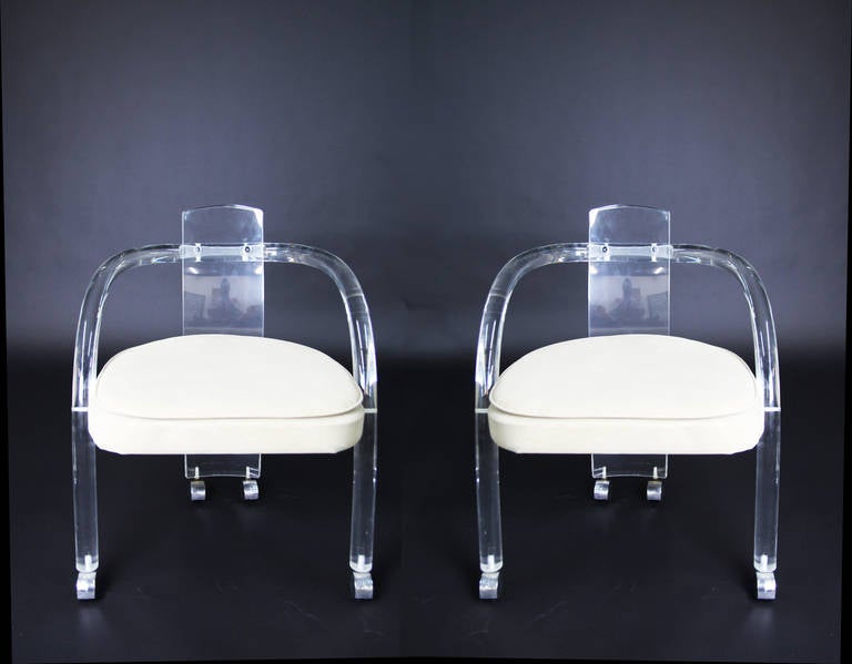 Set of 4 Lucite Arm Chairs with ultra-suede fabric.  In great very clear condition.  On Castors.