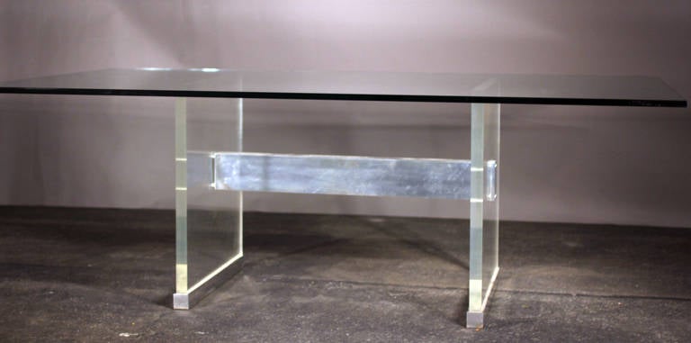 Originally purchased by current owner in 1970 from John Stuart Inc. in New York City, and still accompanied by original receipt, this John Stuart dining table is gorgeous.  Very thick lucite H shaped base with brushed steel cross bar and foot base. 