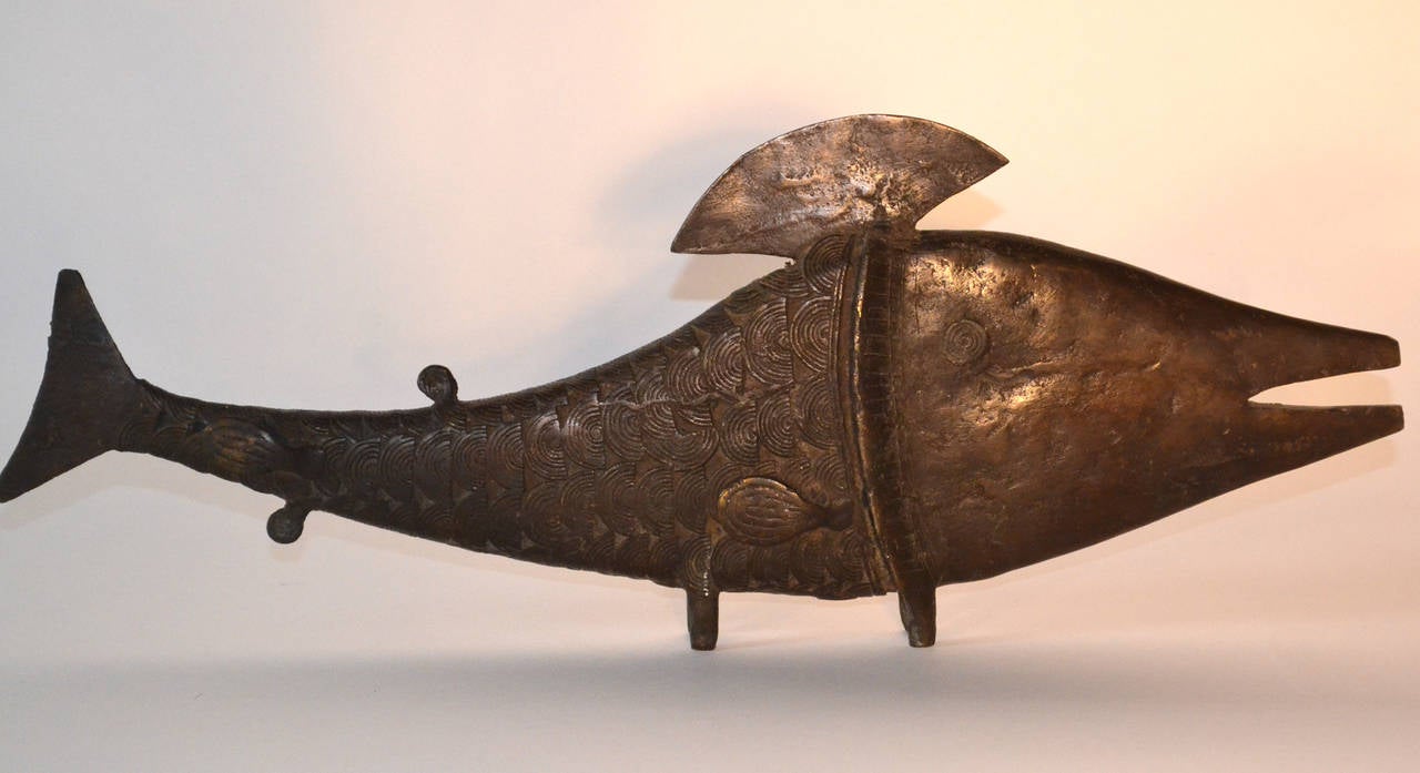 Bronze African fish sculpture crafted by the Benin Tribe, great detail as each scale is crafted of coiled wires. This substantial sculpture would be a dramatic accent to a modernist interior due its simple geometric profile and motifs.