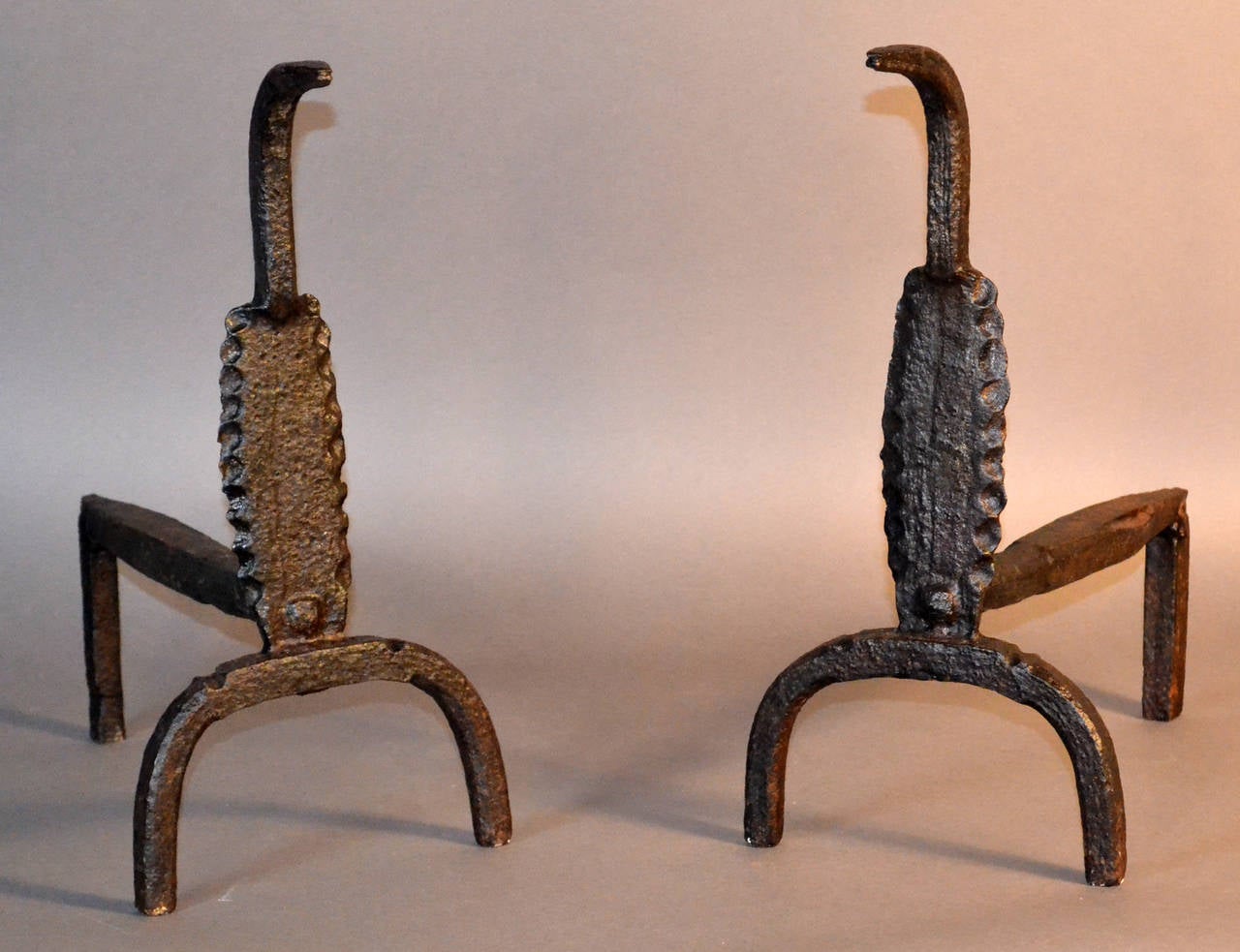 Unusual early hand-forged fireplace andirons in the form of a cobra.