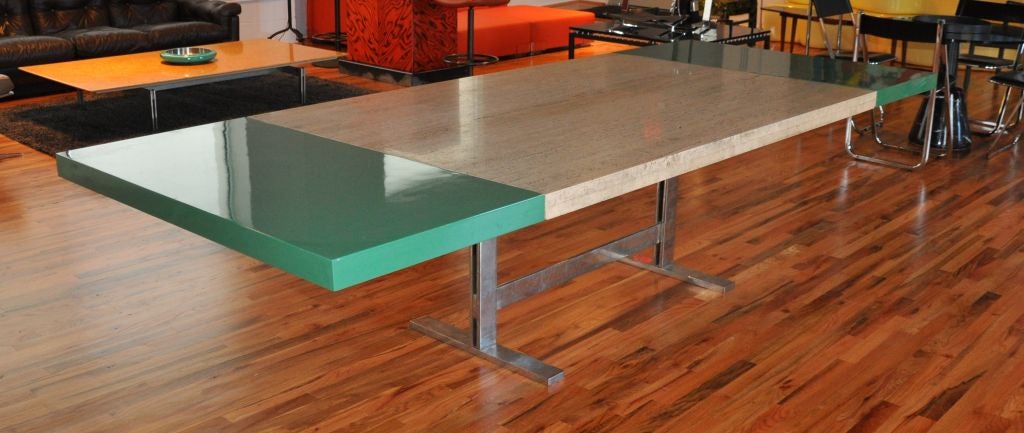 Exceptional dining table in travertine with green lacquered extension leaves on steel base.