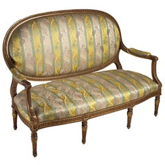 A finely carved and gilded Louis XVI style sofa
