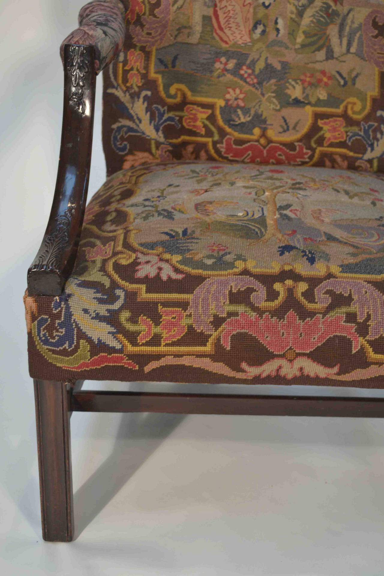 A fine large scale Chippendale style library chair from the mid to late 19thC; the front upholstered in gros and petite point needlework in an oriental design, all of which is in fine condition;  the back of the chair is upholstered in an oyster
